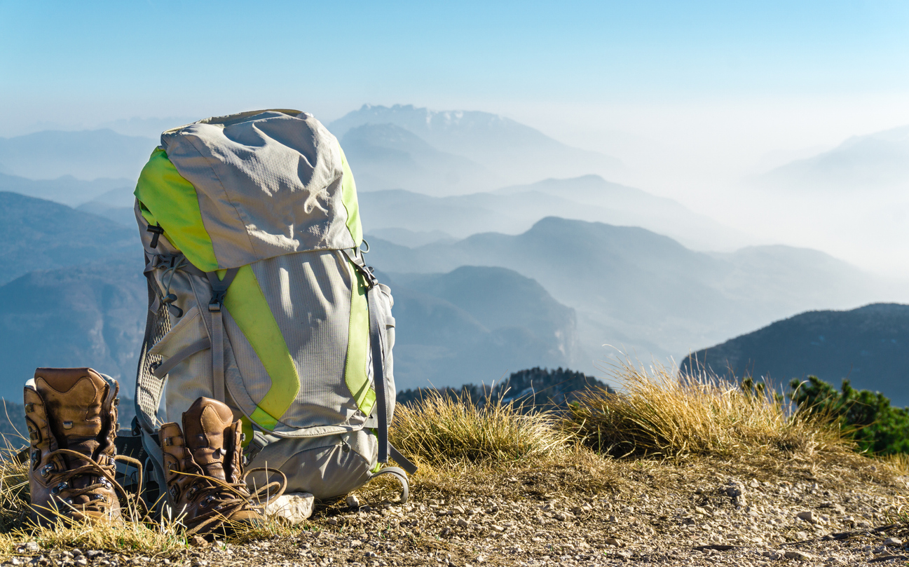 Backpack and boots on top of the mountain
