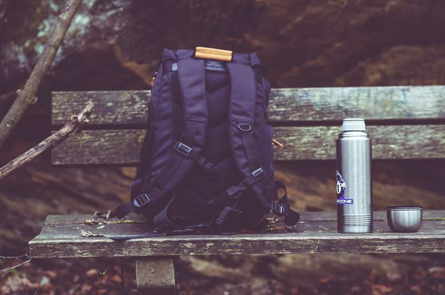 a black backpack on a bench