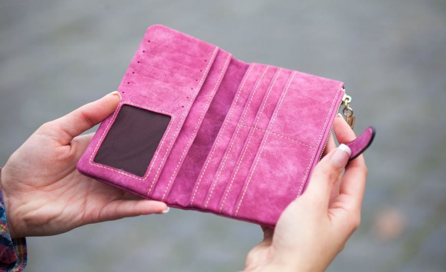person holding a pink wallet