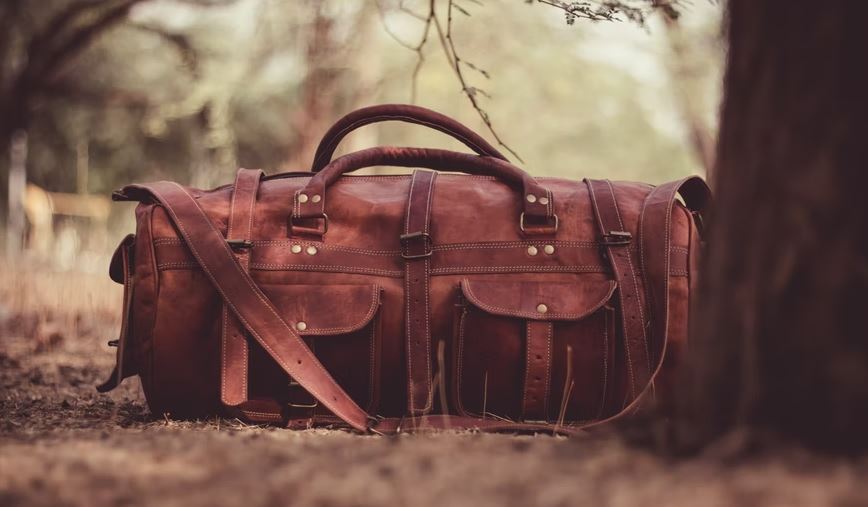 a leather duffle bag on the ground